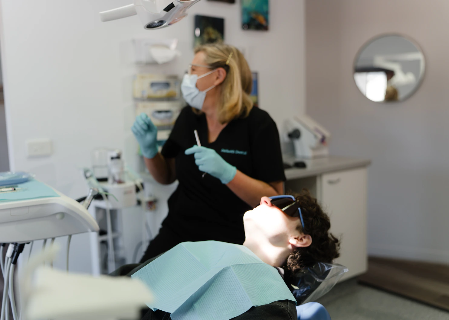 Dalkeith Dental clinician providing non-graphic treatment to a reclined patient