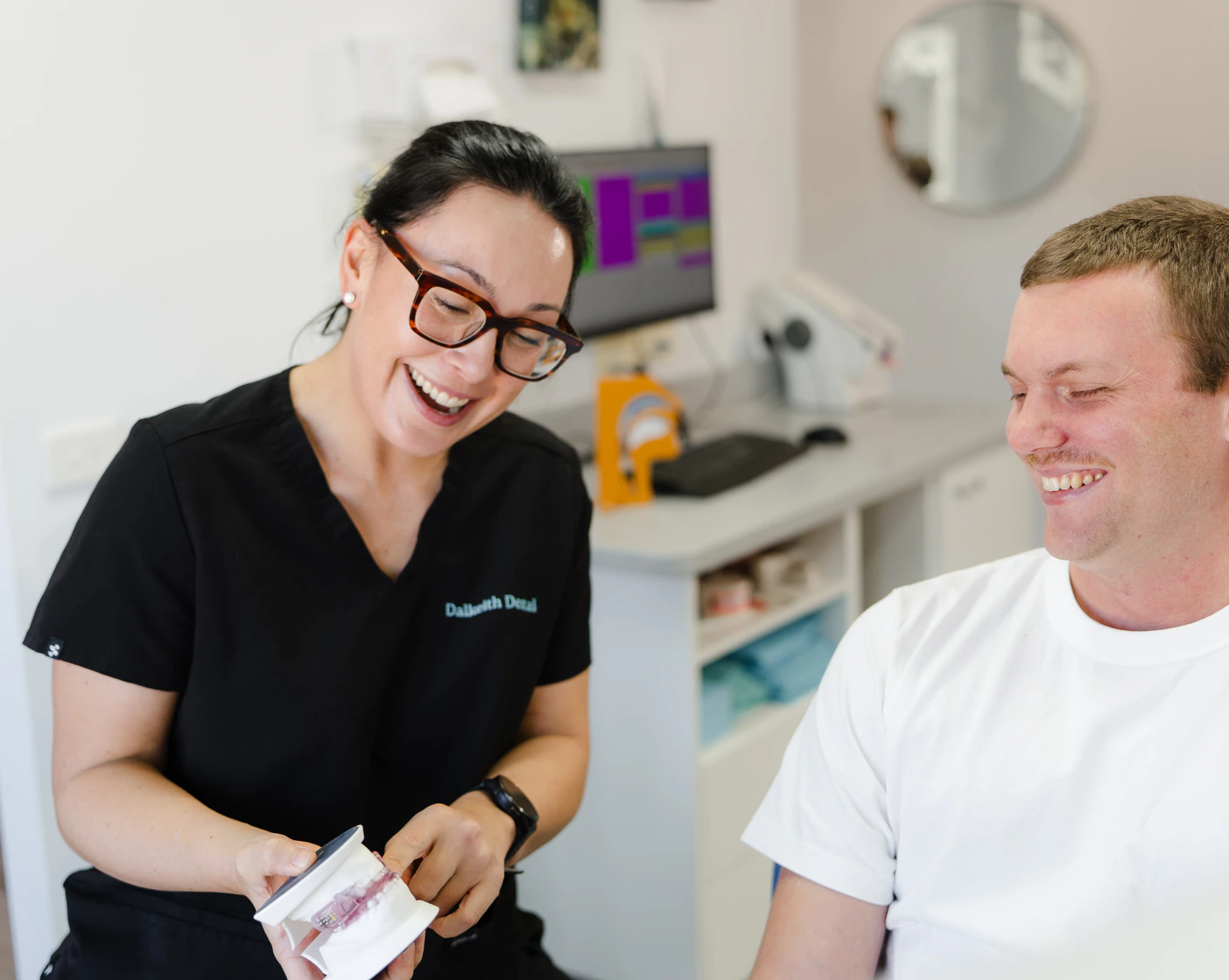 Dalkeith Dental clinician explaining oral hygiene advice with a dental model